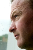 Depressed man looking out window