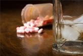 Close up of pills and a glass of whiskey