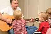 Man teaching toddlers music
