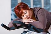 Woman sleeping on exercise bike