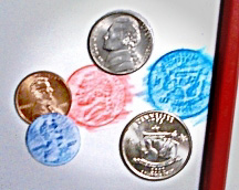 Image of coin rubbings, some cut out.