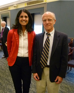 woman and man posing together in conference room