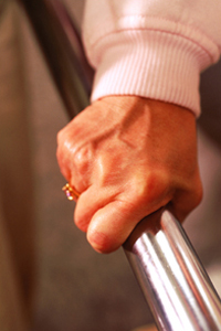 woman grasping a hand rail