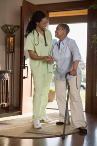 woman using cane with an at-home assistant