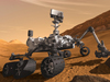In this artist's concept, NASA's Mars Science Laboratory Curiosity rover examines a rock on Mars with a set of tools at the end of the rover's arm, which extends about seven feet. The rover is designed to investigate Mars' past or present ability to sustain microbial life.