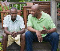 Photo: Father and son talking.