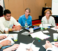 Sarah Lyon Callo and colleagues discuss NACI tools at a 2010 NACI meeting in Baltimore
