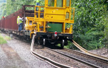 Railcar laying down new track as it moves down the old track