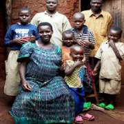 Genevieve Ndagijimana poses with her children. Thanks to USAID, the family now uses mosquito nets to protect against malaria