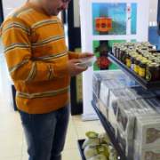 A customer compares high-quality Iraqi foodstuffs at Baghdad International Airport. The duty-free store, featuring several USAID