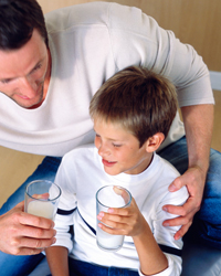 Photo: Father and son with a glass of milk.