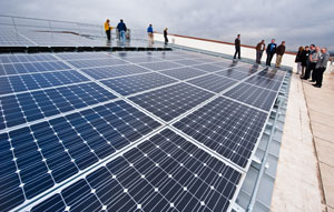 Photo of energy executives touring a rooftop solar installation.