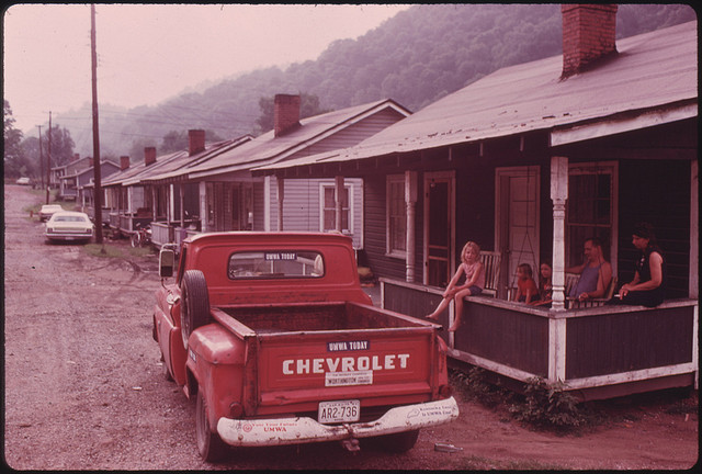 DOCUMERICA: Row of miners' homes in the Brookside Mine Company Town of Brookside Kentucky, near Middlesboro. The mine, owned by the Duke Power Company, was the scene of a protracted and sometimes violent strike between the mine and the United Mine Workers Union during 1974. The strike ended when a man was shot and killed on the picket line in Harlan County. The home of the Jerry Rainey family is in the foreground. They were threatened with eviction during the strike. June, 1974 by Jack Corn.