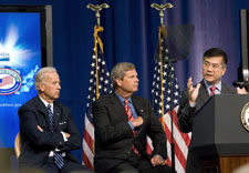 Biden, Vilsack and Locke on stage with flags in background. Click for larger image.