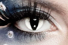 Close-up of a woman's eye with decorative contact in to make her eye look like a cats eye.