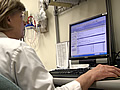 Medical professional in front of a computer monitor