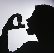 Illustration of person using asthma inhaler.