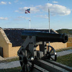 Interior of Fort Moultrie with an 18th-century cannon and an 1809 U.S. flag.