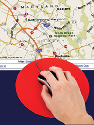 Image of a hand moving a computer mouse over a map