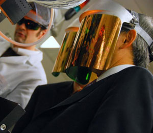 Photo of Secretary Chu wearing a reflective face shield to observe a manufacturing process.