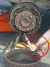 Photo showing brake dust being blown away using compressed air. This practice is strongly discouraged