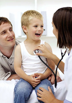 Female doctor examining a boy