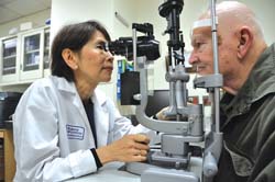 Dr. Emily Chew conducting an eye exam 