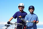 Photo: Two young boys wearing helmets with bikes