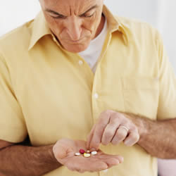 Photo: Man taking prescription pills