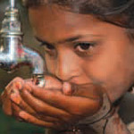 A photograph of a girl drinking water out of her hands
