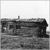 Thumbnail image of a log house with a sod roof.