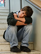 Boy sitting on steps alone