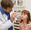 Doctor examining girl with stethoscope 