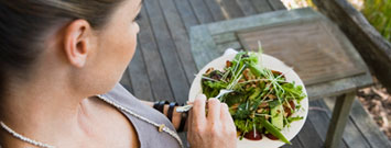 Photo: A woman eating a healthy salad.