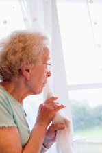 Elderly woman looking about window