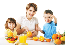 A mother cutting oranges for a snack