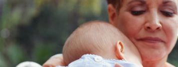 Photo: A woman holding a baby.