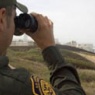 Border patrolman with binoculars