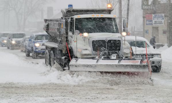 Snow plow working during a blizzard.
