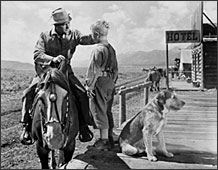 Alan Ladd and Brandon deWilde in <em>Shane.</em>