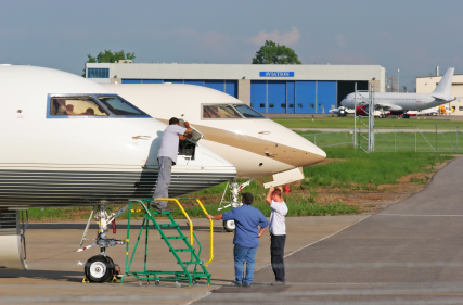 Two airplanes being serviced.