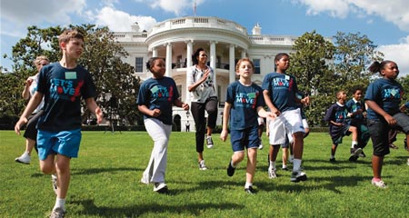 US First Lady Michelle Obama running with children