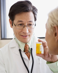 Photo: A healthcare provider discussing prescription medicine with a patient.