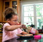 Photo: Child making peanut butter sandwich