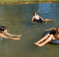 children swimming in lake