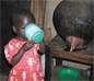 Global Water, Sanitation, and Hygiene (WASH)- girl drinking water out of large cup in Africa