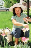 Photo: A woman applying insect repellent