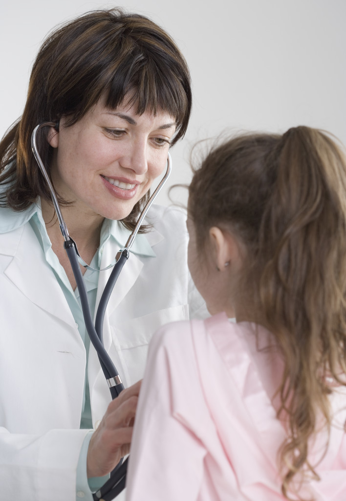 Pediatrician checking little girl