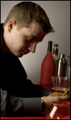 A man drinking an alcoholic beverage