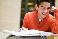 Photo: Teenage boy studying and smiling